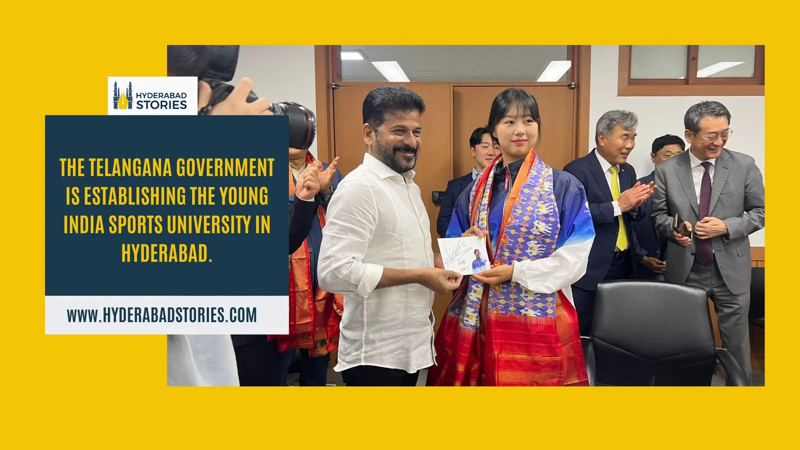 News graphic of officials exchanging a memento at an indoor ceremony