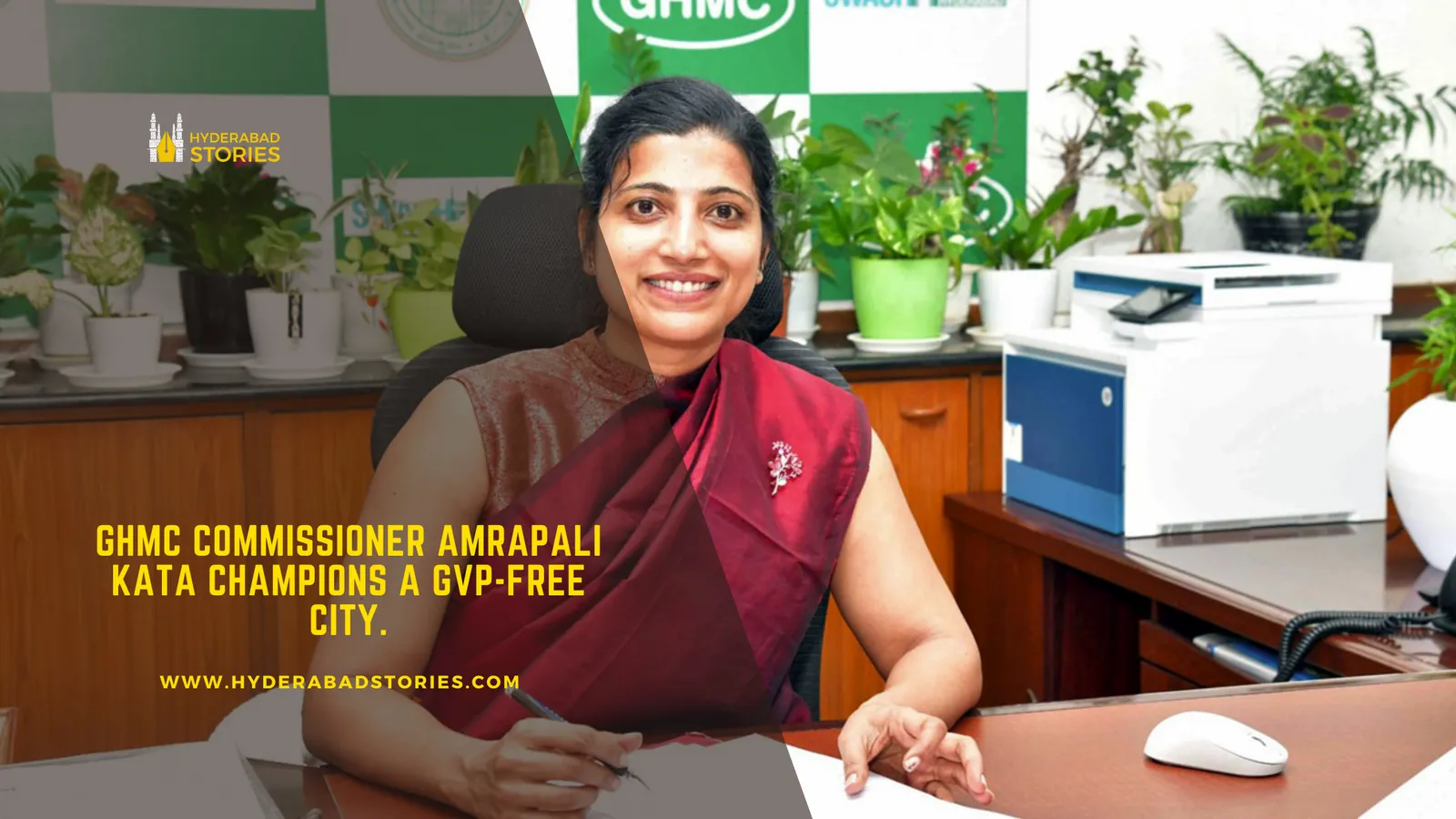 News graphic of a woman in a sari seated at an office desk with plants behind