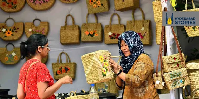 News graphic of women examining woven cane bags at a craft stall