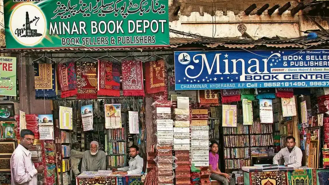 Street view of a bookshop frontage stacked with books and signage