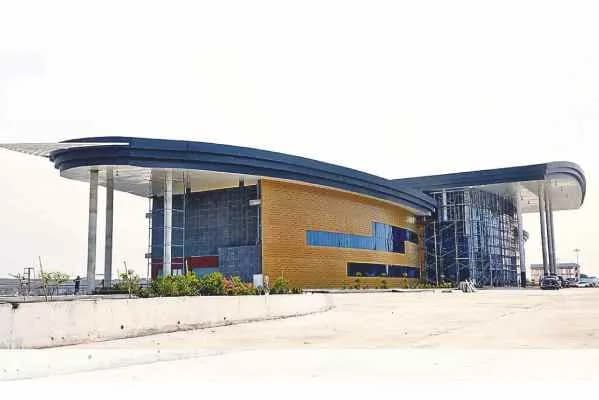 Modern terminal building with a curved canopy roof seen from outside