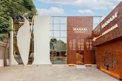 Modern retail building frontage with a decorative screen and signage