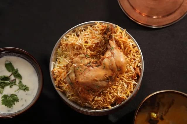 A plate of Hyderabadi chicken biryani with raita