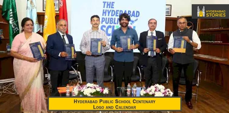 People holding up a calendar at an indoor school ceremony