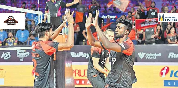 Volleyball players celebrating during an indoor match