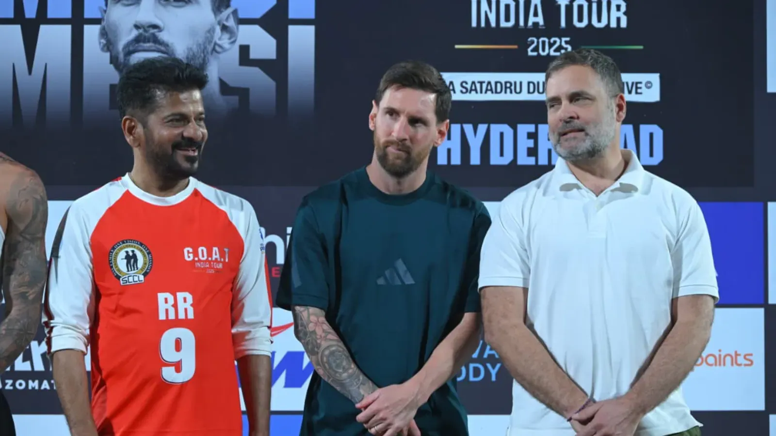 Three men standing together at a promotional event