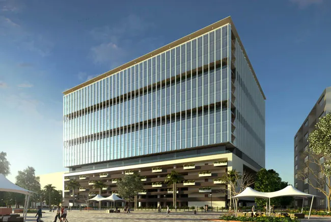 Multi-storey glass office building beside a landscaped forecourt