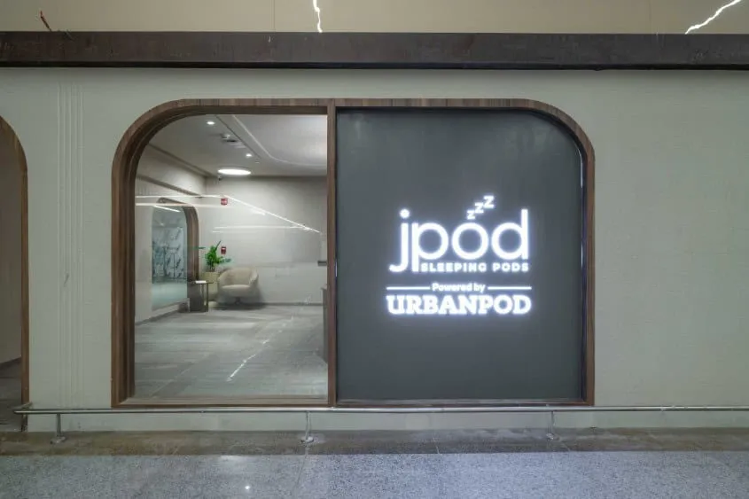 Entrance to a sleeping pod facility with an illuminated sign