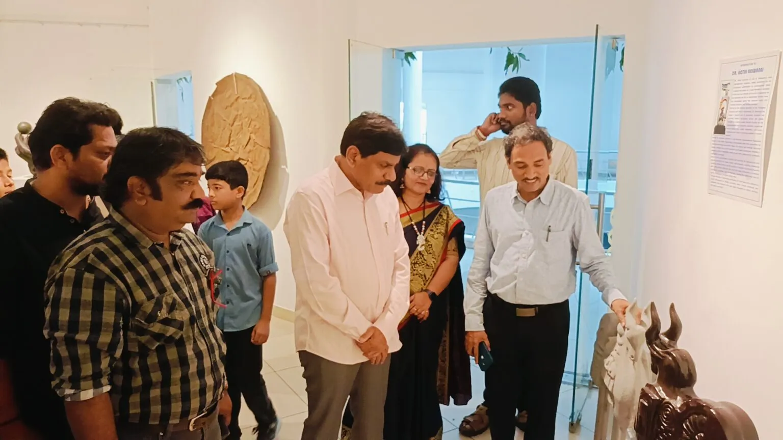 Visitors viewing sculptures in a gallery