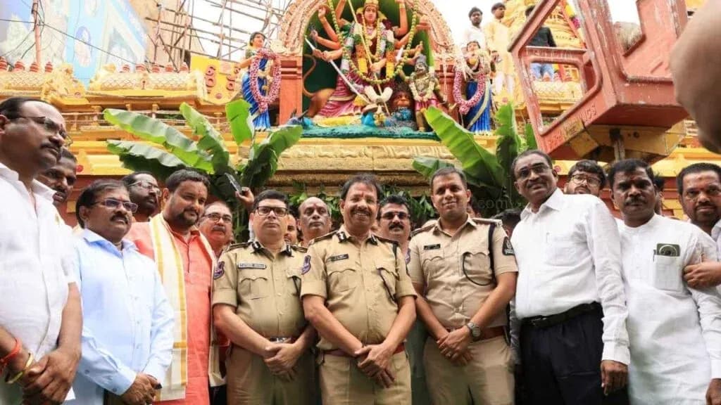 Group posed with police officers before a decorated shrine