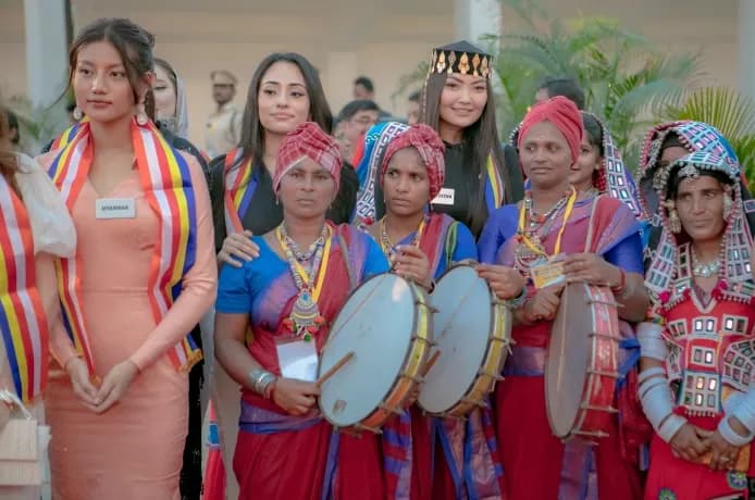 Women in bright traditional dress with drums and sashes
