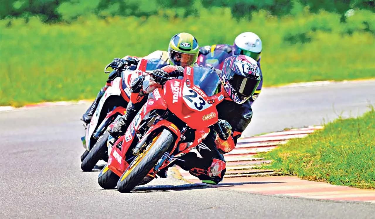 Motorcycle racers cornering on a racetrack