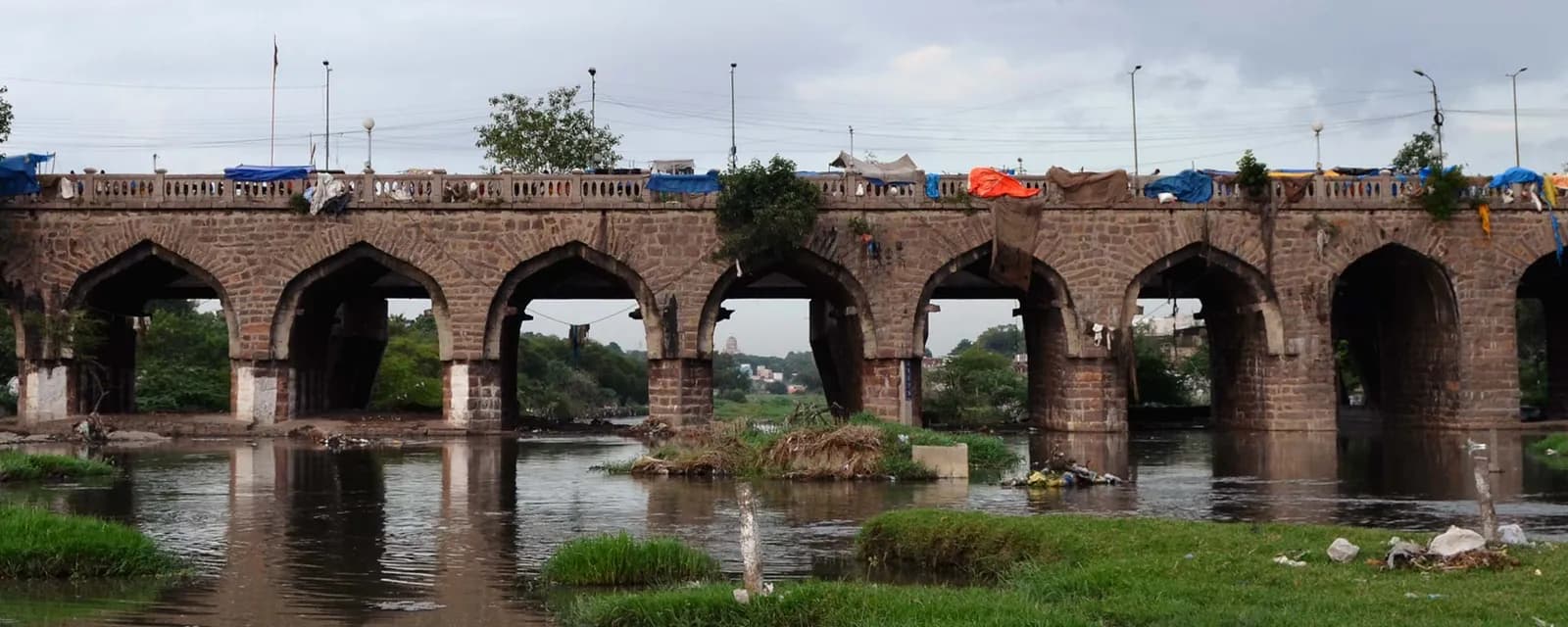 Old arched stone bridge over a river