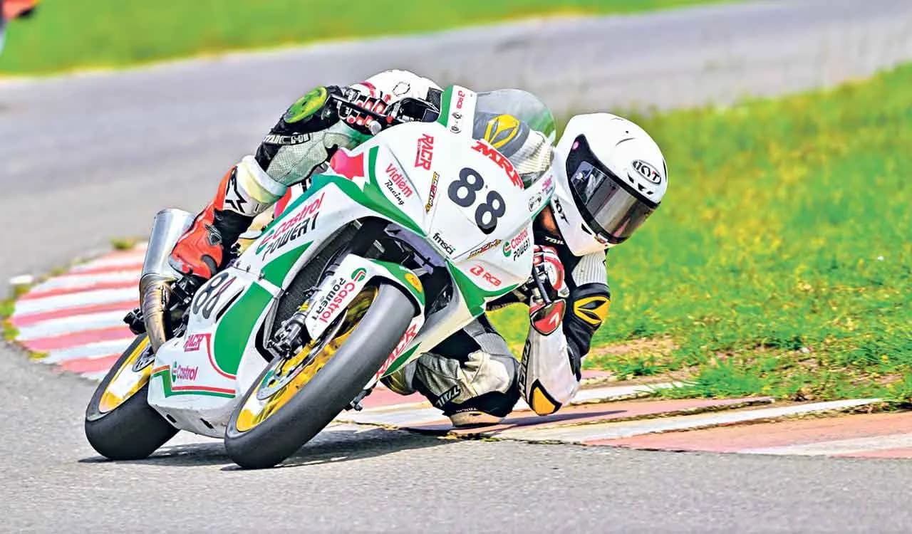Motorcycle racer cornering on a racetrack