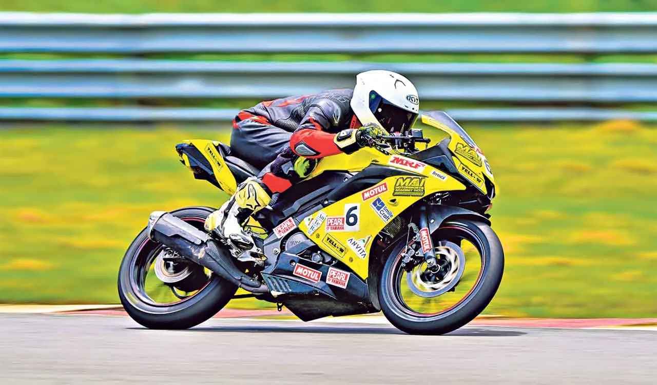 Motorcycle racer cornering on a racetrack