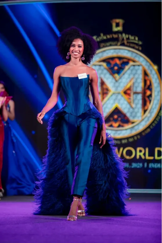 Woman in a blue outfit on a lit stage