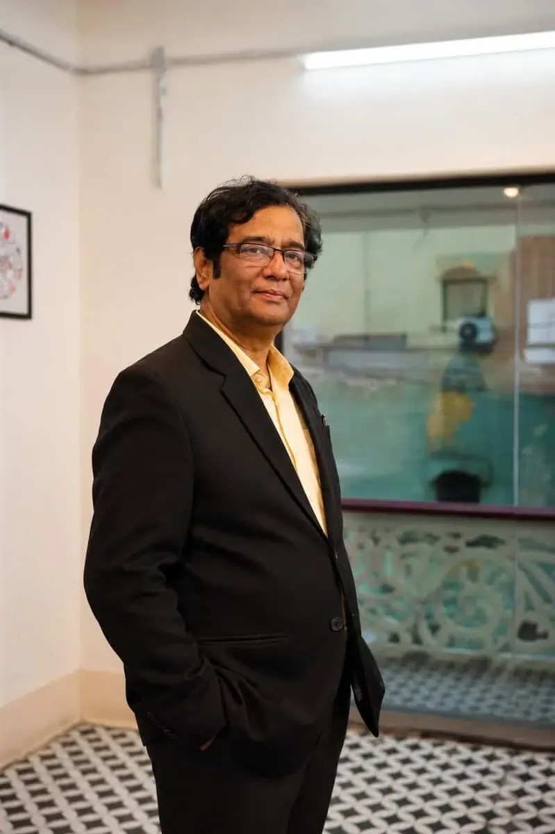 Man in a suit standing in an office corridor