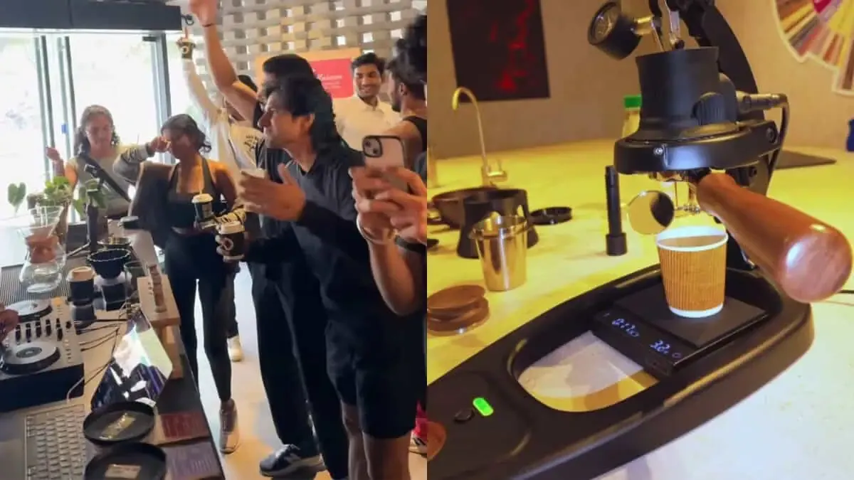 People holding drinks beside a coffee machine