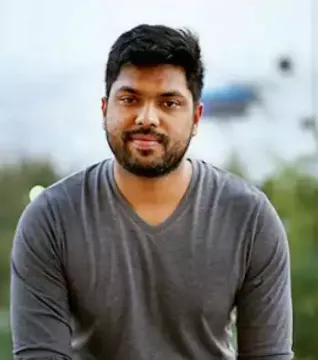 Portrait of a man in a grey top outdoors