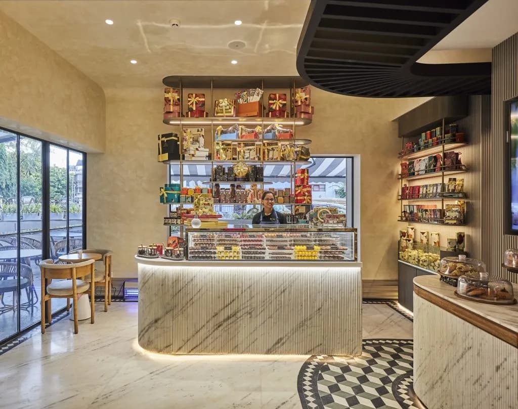 Interior of a patisserie with a display counter and shelving