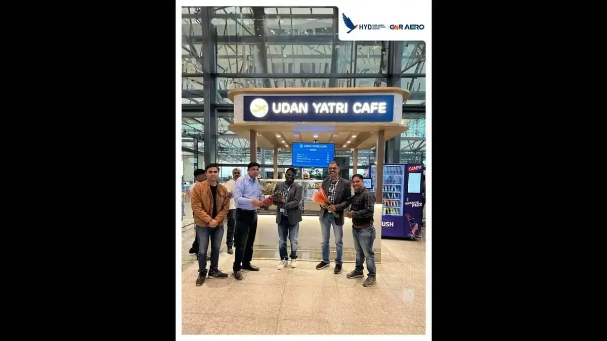 People standing at an airport cafe counter