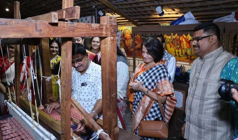 People watching a weaver working at a handloom
