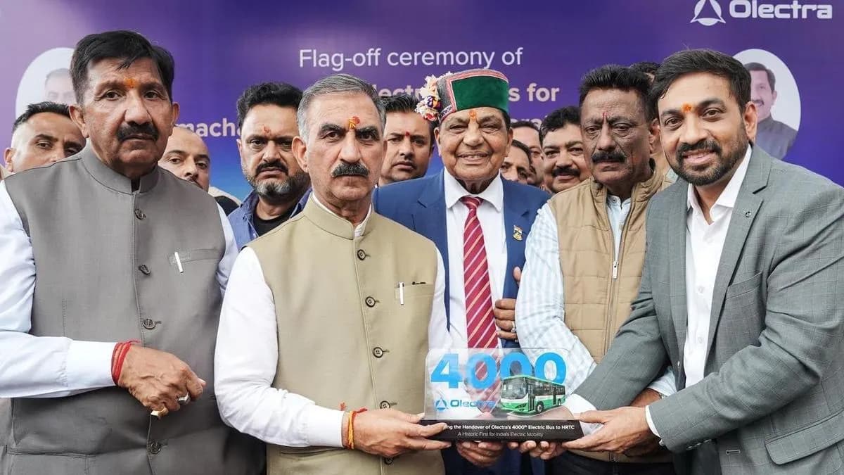 People holding a memento at a vehicle flag-off ceremony